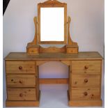 A modern waxed pine dressing table, with rectangular plate and two drawers above six drawers,