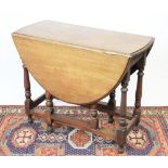 A 1920's oak gate leg table,