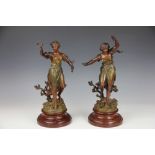 A pair of late 19th century French bronzed spelter figures, on faux marble bases,