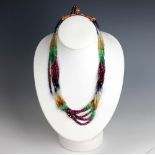 A six strand multi-gem set bead necklace, probably Indian, comprising alternating sapphire, emerald,