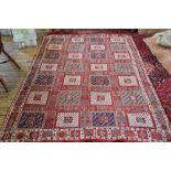 A Mediterranean hand knotted wool wall hanging, worked with various geometric squares,