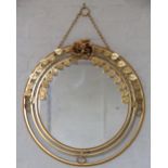 A pair of modern brass circular wall mirrors, with flower and leaf garland detailing,