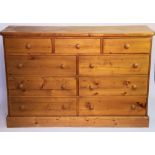 A modern pine chest, with three short drawers and six long drawers, on plinth base,