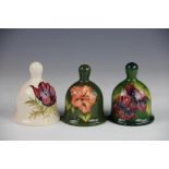 Three Moorcroft bells, to include a Hibiscus pattern against a green ground, dated '86',