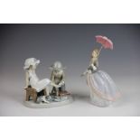 Two Lladro figures, to include; a boy and girl trying on shoes 5361 14.