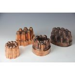 Four 19th century copper jelly moulds, two oval numbered 116 and 57,