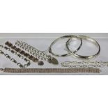 A collection of silver bracelets, to include; a fancy link bracelet stamped '925S England',