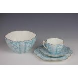 A Foley Chine Wileman Shelley trio, decorated with panels of snowdrops in pale blue, pattern 9180,