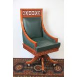 A Chinese carved hardwood desk swivel chair, on out-swept legs,