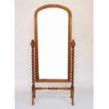 A modern pine cheval mirror, with barley twist uprights, on scroll legs,