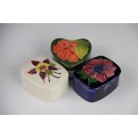 Three Moorcroft boxes and covers, to include; two rectangular in the Aquilegia pattern, 7.