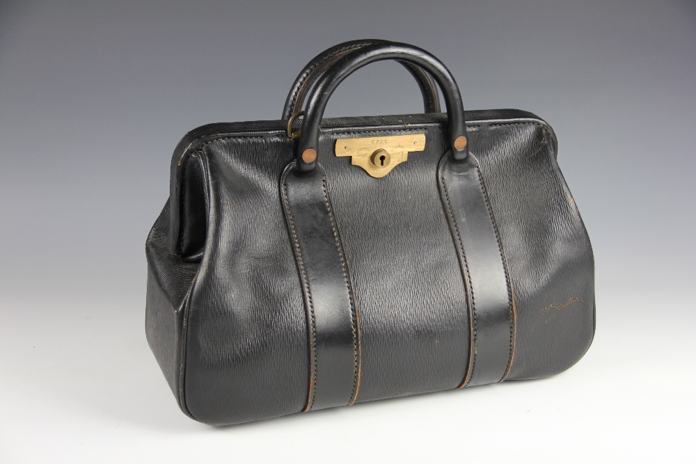 A black leather doctors bag, with tan leather interior and Hobbs & Co brass clasp numbered C752,