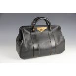 A black leather doctors bag, with tan leather interior and Hobbs & Co brass clasp numbered C752,