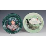 Two Moorcroft plates, to include; a tree landscape decorated example, signed 'J Moorcroft 23.10.