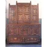 A carved oak cabinet converted from an 18th century mule chest,