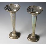 A large pair of silver trumpet vases, of square form with pierced rims, on canted swept bases,