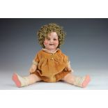 A German Shirley Temple doll, composition head and body, with sleeping eyes and open mouth,