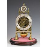 A late 19th century gilt brass fusee skeleton clock with silvered Roman numeral chapter ring above