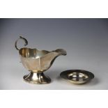 A George V silver sauce boat, with flying scroll handle, Sheffield 1934,