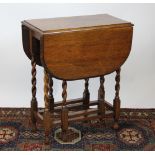 A 1920's oak gate leg table,
