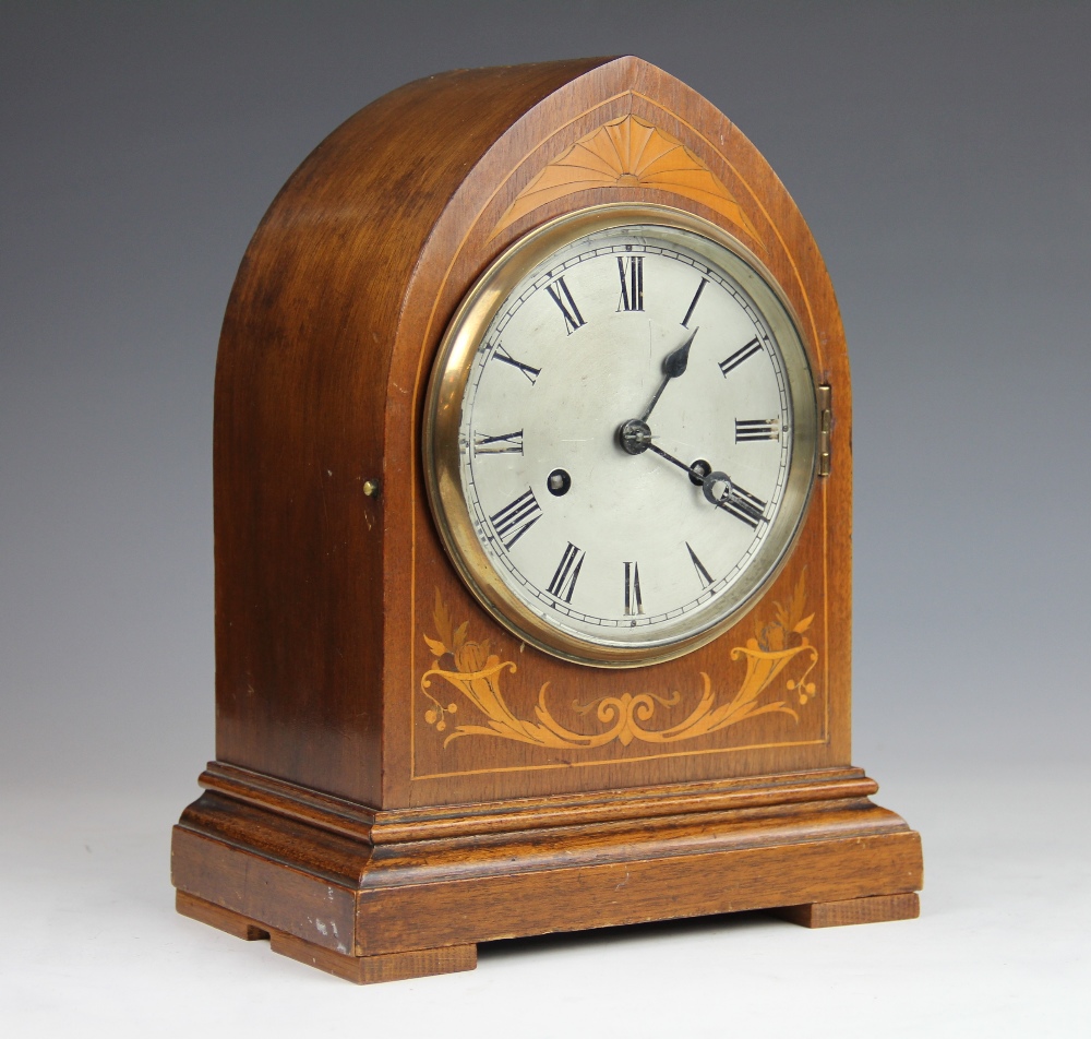 An Edwardian inlaid mahogany lancet shape mantle clock, with movement striking on two gongs,
