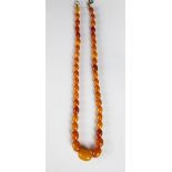 An Amber bead necklace, the forty two amber beads (measuring from 8mm - 18mm wide),