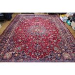 A large Persian hand woven wool Mashad carpet,