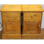 A pair of modern waxed pine bedside tables, with three drawers, on plinth base,