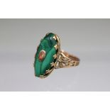 A Victorian malachite set dress ring, the navette shaped malachite within yellow metal claw setting,