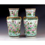 A pair of Chinese famille rose vases, Qing Dynasty, each of high shouldered, waisted form,
