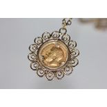 An Edwardian VII gold half sovereign, 1912, in 9ct gold mount and yellow metal chain, 15.