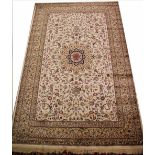 A Kashmir carpet, worked with an all over foliate design against a ivory ground,