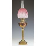 A Victorian brass and copper oil lamp, with moulded and etched graduated pink glass shade,