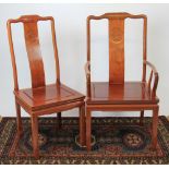 A Chinese hardwood extending dining table and ten chairs,