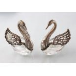 A pair of Continental silver and cut glass sweet meat dishes, modelled as swans,