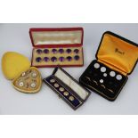 A set of twelve white metal backed amethyst glass buttons, in fitted Morocco leather box,