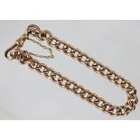 A 9ct gold curb link bracelet, Chester 1901, with attached swivel clasp and safety chain,