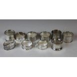 A collection of ten silver napkin rings, some initialled,