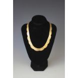 An 18ct yellow gold collarette necklace, with graduated fringe and matt effect finish,