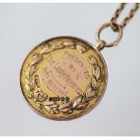 A 9ct yellow gold swimming medallion dated 1919, with an attached chain (unmarked), total weight 22.