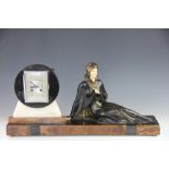 An Art Deco three colour marble figural clock garniture,