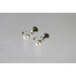 A pair of untested pearl set screw earrings,