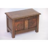 A 1920's small oak coffer, with carved detailing,