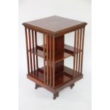 An Edwardian inlaid mahogany revolving bookcase, with central parquetry motif to the top,