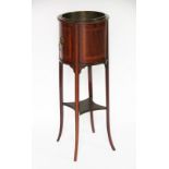 An Edwardian inlaid mahogany jardiniere stand, of cylindrical form, with lion mask loop handles,