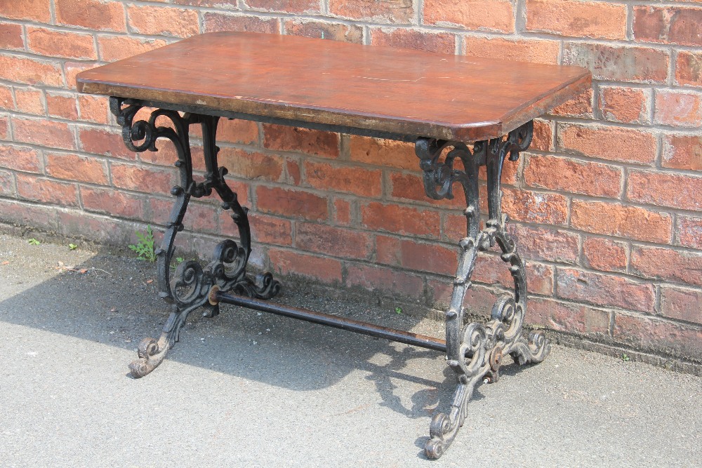 A cast iron garden table, with stained pine top, 70cm H x 103cm W x 55cm D,