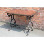 A cast iron garden table, with stained pine top, 70cm H x 103cm W x 55cm D,