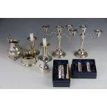 A collection of silver plate, comprising a pair of candlesticks,