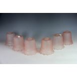 A set of six late Victorian frosted pink glass light shades,