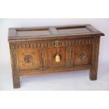 A George III oak coffer, with three panelled front, on stile feet,